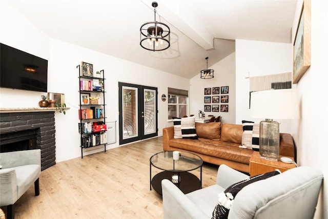 311 Quarry St, San Marcos, TX 78666 - living area with a chandelier, light wood-style floors, and a fireplace