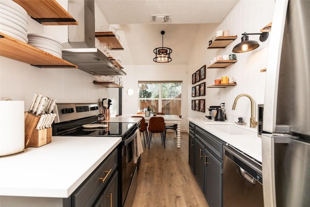 311 Quarry St, San Marcos, TX 78666 - kitchen with open shelves, appliances with stainless steel finishes, a sink, and wall chimney range hood