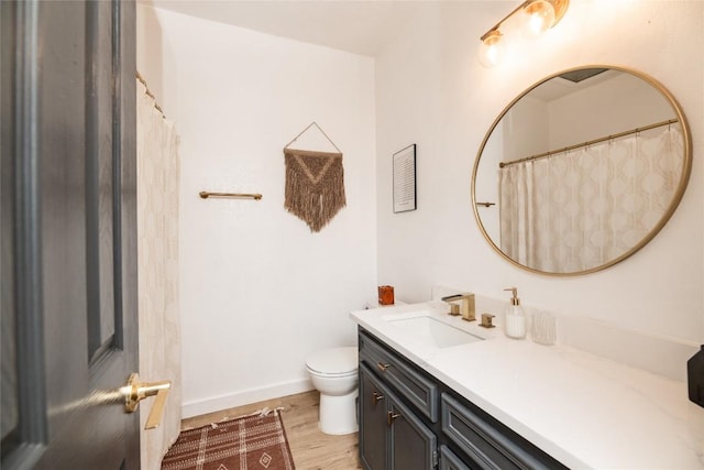 311 Quarry St, San Marcos, TX 78666 - bathroom with toilet, wood finished floors, vanity, and baseboards