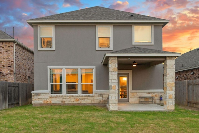 209 Sage Derby Dr, Hutto, TX 78634 - rear view of property with stone siding, stucco siding, roof with shingles, and a patio