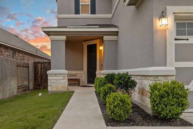 209 Sage Derby Dr, Hutto, TX 78634 - exterior entry at dusk with stucco siding and stone siding