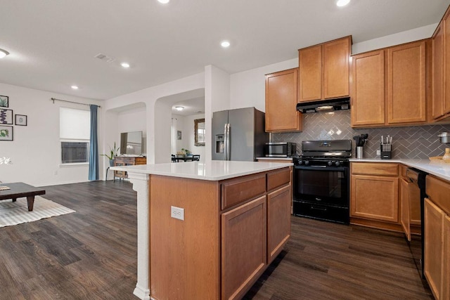 209 Sage Derby Dr, Hutto, TX 78634 - kitchen with black appliances, under cabinet range hood, dark wood-type flooring, a kitchen island, and recessed lighting