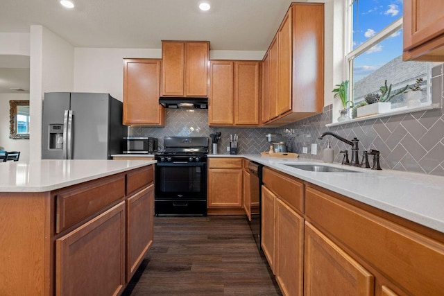 209 Sage Derby Dr, Hutto, TX 78634 - kitchen with black appliances, a sink, extractor fan, tasteful backsplash, and light countertops