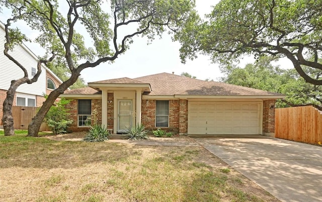10803 Redgate Ln, Austin, TX 78739 - view of front of house featuring a garage, concrete driveway, brick siding, and a shingled roof
