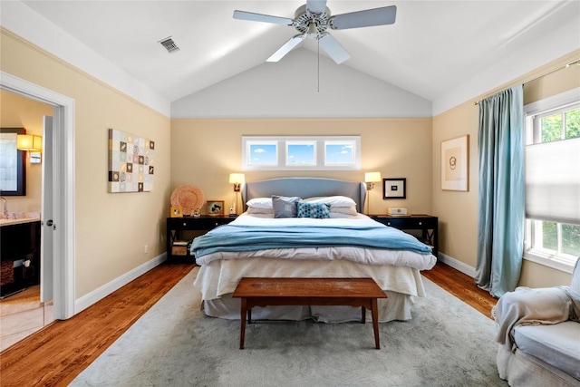 1704 W 34th St, Austin, TX 78703 - bedroom featuring wood finished floors, lofted ceiling, ensuite bathroom, baseboards, and a ceiling fan