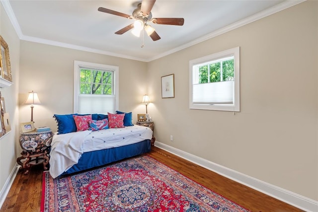 1704 W 34th St, Austin, TX 78703 - bedroom featuring wood finished floors, multiple windows, baseboards, and ornamental molding