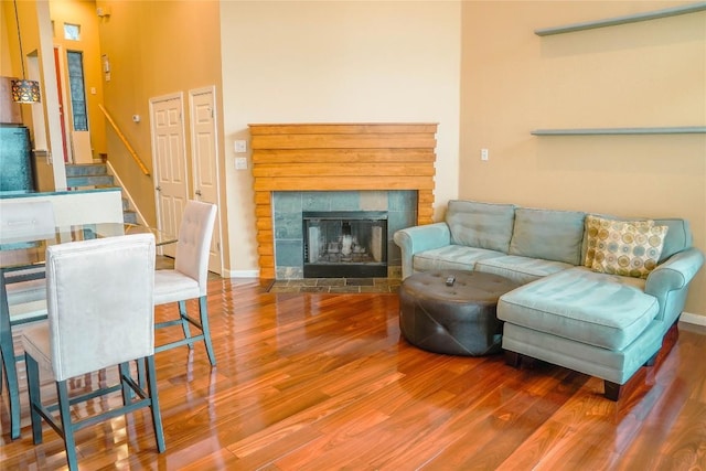 2918 Ranch Road 620th Rd N Unit J162, Austin, TX 78734 - living area featuring wood finished floors, stairs, a tile fireplace, and baseboards