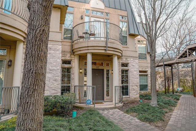 2918 Ranch Road 620th Rd N Unit J162, Austin, TX 78734 - view of exterior entry featuring a balcony and stone siding