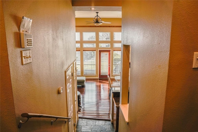 2918 Ranch Road 620th Rd N Unit J162, Austin, TX 78734 - hallway with stone tile flooring, a textured wall, and a high ceiling