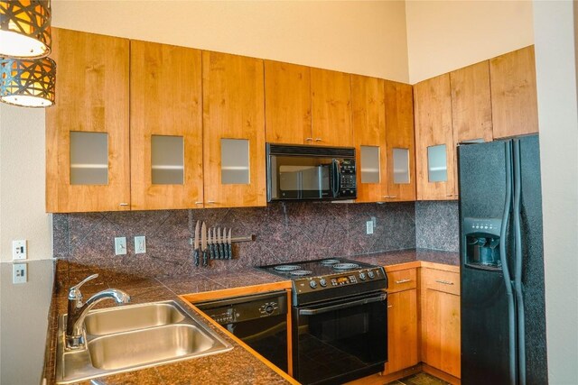 2918 Ranch Road 620th Rd N Unit J162, Austin, TX 78734 - kitchen with black appliances, a sink, decorative backsplash, and brown cabinets