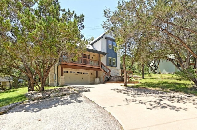 1502 Medio Calle, Austin, TX 78733 - view of front of house featuring stairway, concrete driveway, a garage, a front yard, and stone siding