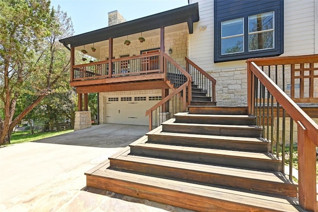 1502 Medio Calle, Austin, TX 78733 - view of front of property with stairs, stone siding, a garage, driveway, and a chimney