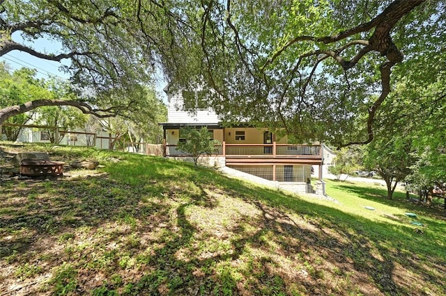 1502 Medio Calle, Austin, TX 78733 - view of grassy yard featuring a fire pit and a wooden deck