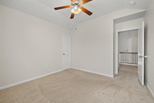 711 Rolling Oak Dr Unit 106, Round Rock, TX 78664 - spare room featuring light carpet, ceiling fan, a smoke detector, vaulted ceiling, and baseboards