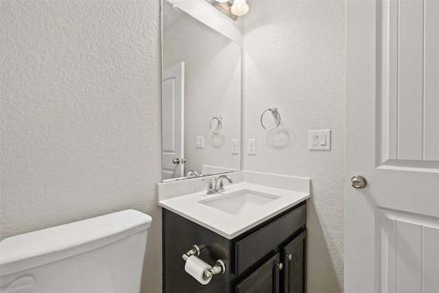711 Rolling Oak Dr Unit 106, Round Rock, TX 78664 - bathroom with a textured wall, toilet, and vanity
