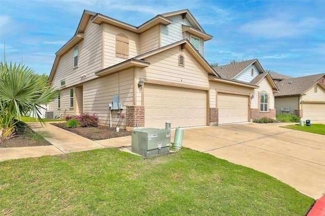 711 Rolling Oak Dr Unit 106, Round Rock, TX 78664 - view of side of property featuring brick siding, driveway, and a lawn