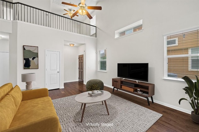 711 Rolling Oak Dr Unit 106, Round Rock, TX 78664 - living area with wood finished floors, a high ceiling, a ceiling fan, and baseboards