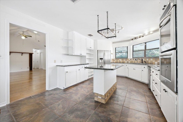 4451 County Road 467, Elgin, TX 78621 - kitchen with open shelves, appliances with stainless steel finishes, white cabinetry, tasteful backsplash, and ceiling fan