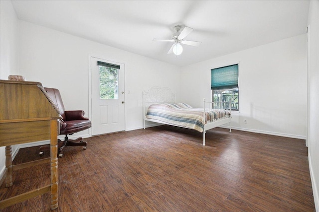 4451 County Road 467, Elgin, TX 78621 - bedroom with multiple windows, wood finished floors, and baseboards