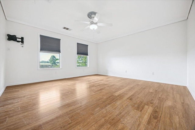 4451 County Road 467, Elgin, TX 78621 - empty room with wood finished floors, a ceiling fan, baseboards, and ornamental molding