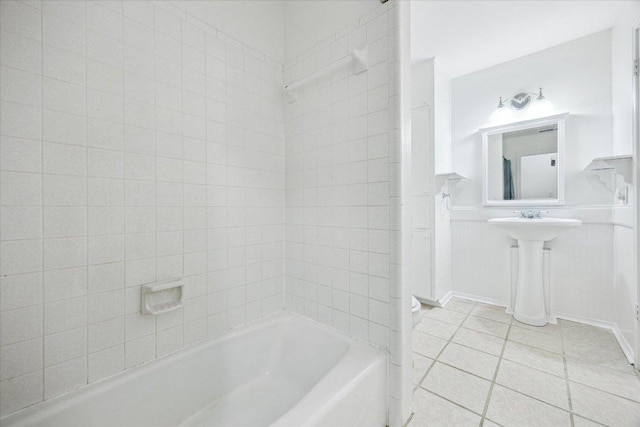 4451 County Road 467, Elgin, TX 78621 - full bath with tile patterned flooring,  shower combination, a wainscoted wall, and a sink