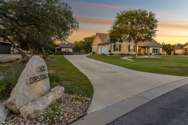 400 Capstone Dr, Marble Falls, TX 78654 - view of front of property featuring concrete driveway, a yard, and an attached garage