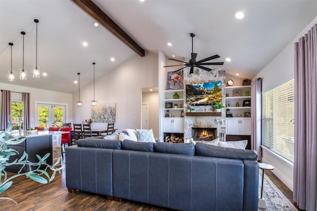 400 Capstone Dr, Marble Falls, TX 78654 - living area featuring dark wood-style flooring, ceiling fan, high vaulted ceiling, a stone fireplace, and beam ceiling
