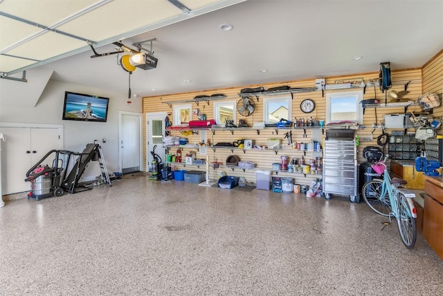 400 Capstone Dr, Marble Falls, TX 78654 - garage featuring a garage door opener and wood walls