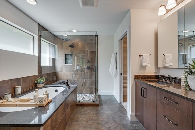 2502 Spring Creek Dr, Austin, TX 78704 - full bathroom with a stall shower, a garden tub, vanity, and baseboards