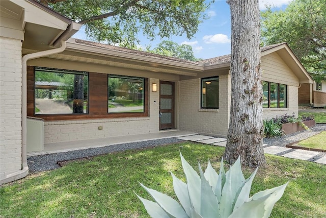 2502 Spring Creek Dr, Austin, TX 78704 - property entrance featuring brick siding and a yard