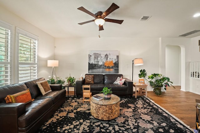 900 Lily Pad, Leander, TX 78641 - living area with ceiling fan, arched walkways, wood finished floors, and baseboards