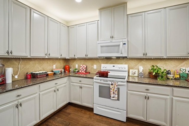 900 Lily Pad, Leander, TX 78641 - kitchen featuring white appliances, decorative backsplash, dark stone counters, and dark wood finished floors