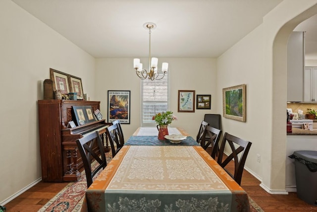 900 Lily Pad, Leander, TX 78641 - dining room with dark wood-style floors, arched walkways, a chandelier, and baseboards
