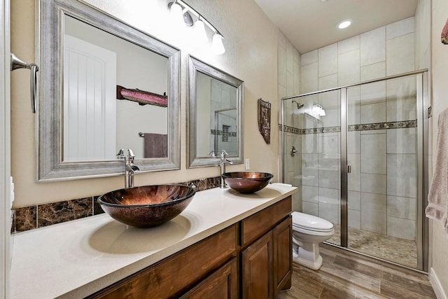 118 S John Bird, Blanco, TX 78606 - full bath with double vanity, a stall shower, wood finished floors, toilet, and recessed lighting