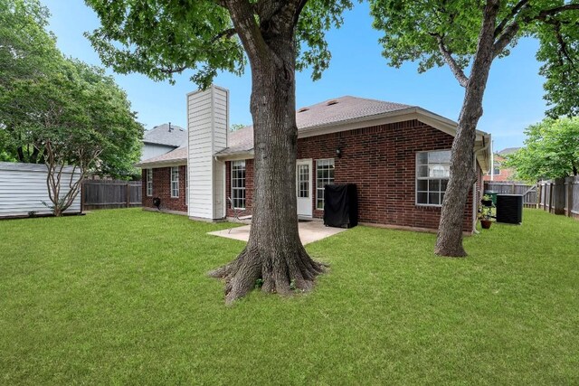 1111 Pebble Brook Rd, Cedar Park, TX 78613 - back of property with a fenced backyard, brick siding, and a patio