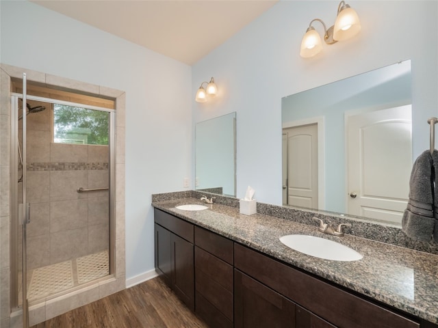 116 Naalehu Ct, Bastrop, TX 78602 - full bath featuring a shower stall, wood finished floors, double vanity, and baseboards