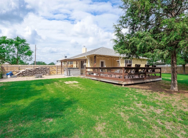 116 Naalehu Ct, Bastrop, TX 78602 - back of property with a hot tub, a deck, and a chimney