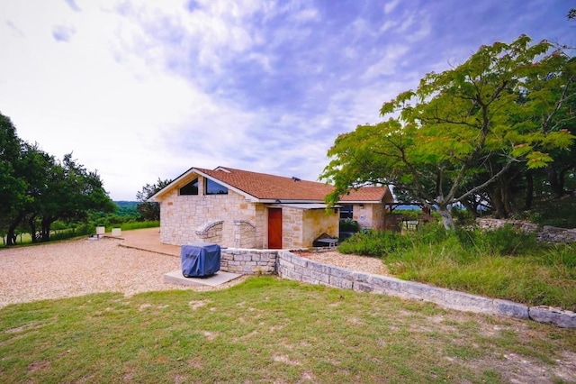 1231 Montell Rd, Wimberley, TX 78676 - view of side of property with stone siding and a lawn