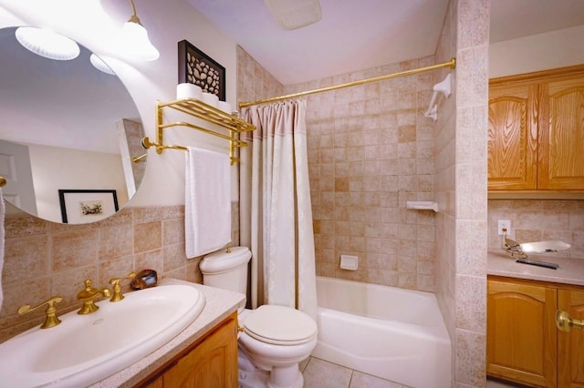 1231 Montell Rd, Wimberley, TX 78676 - bathroom with vanity, tile walls, toilet, shower / bath combo with shower curtain, and tasteful backsplash