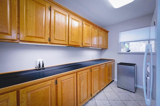 1231 Montell Rd, Wimberley, TX 78676 - laundry area featuring light tile patterned flooring and baseboards