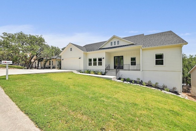 2803 Wilson Ave, Lago Vista, TX 78645 - modern farmhouse featuring concrete driveway, an attached garage, a front lawn, a shingled roof, and board and batten siding