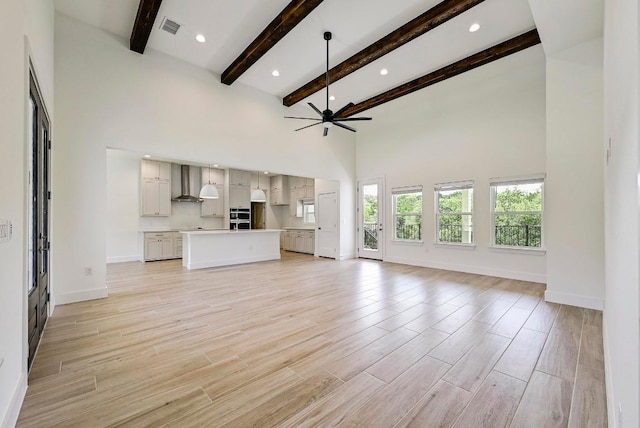 2803 Wilson Ave, Lago Vista, TX 78645 - unfurnished living room with ceiling fan, a high ceiling, beam ceiling, light wood-style floors, and recessed lighting