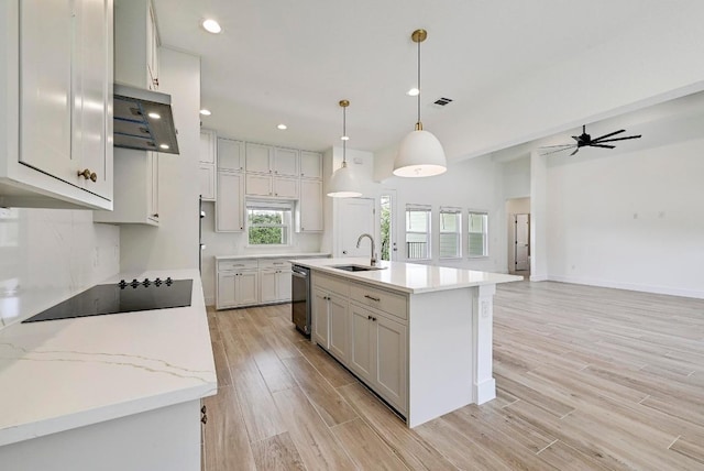 2803 Wilson Ave, Lago Vista, TX 78645 - kitchen with black electric cooktop, light wood finished floors, dishwasher, recessed lighting, and an island with sink
