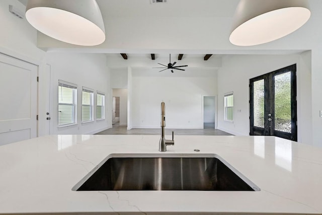 2803 Wilson Ave, Lago Vista, TX 78645 - kitchen with open floor plan, light stone countertops, plenty of natural light, and french doors