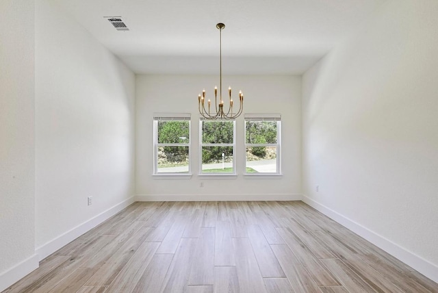 2803 Wilson Ave, Lago Vista, TX 78645 - empty room featuring a chandelier and light wood-style flooring