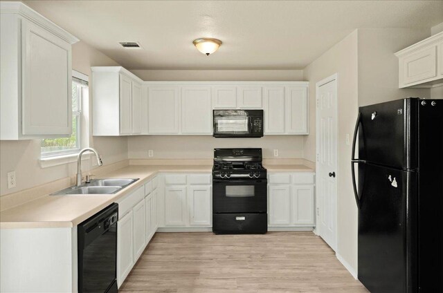 15411 Ora Ln, Pflugerville, TX 78660 - kitchen featuring black appliances, white cabinetry, and light countertops