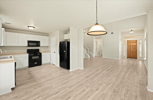 15411 Ora Ln, Pflugerville, TX 78660 - kitchen featuring black appliances, a sink, light wood-style flooring, light countertops, and white cabinetry