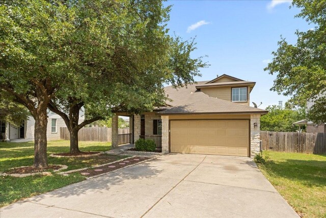 15411 Ora Ln, Pflugerville, TX 78660 - view of front of property featuring stone siding, driveway, and an attached garage