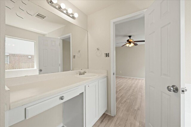 15411 Ora Ln, Pflugerville, TX 78660 - bathroom featuring ceiling fan, vanity, and wood finished floors