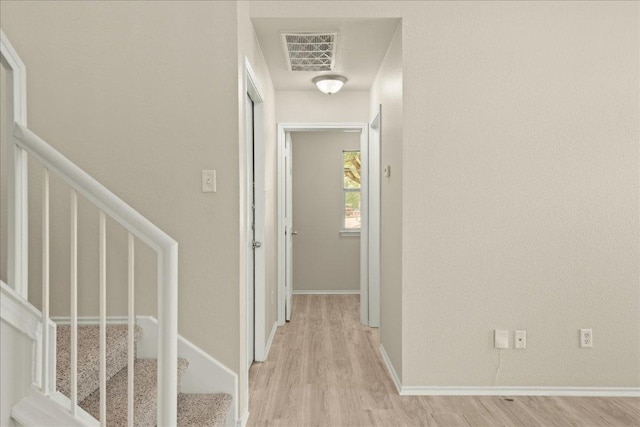 15411 Ora Ln, Pflugerville, TX 78660 - hallway with light wood-type flooring, baseboards, and stairs
